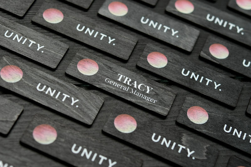 Black stained Unity plywood name badge with printed logo